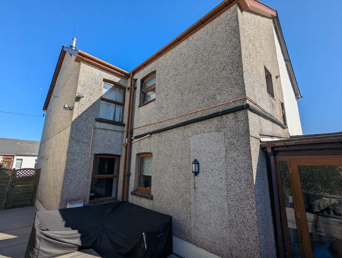 A rendered two-storey house in Torfaen under a blue sky, typical of the properties we work on